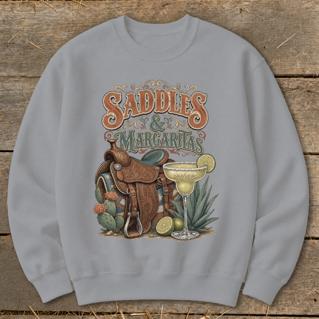 Crewneck sweatshirt with "Saddles & Margaritas" graphic featuring a saddle, margarita, and cacti.