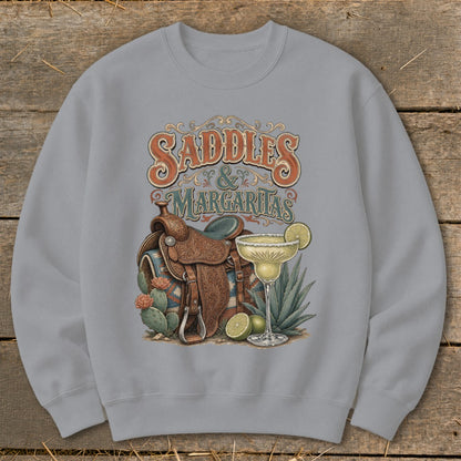 Crewneck sweatshirt with "Saddles & Margaritas" graphic featuring a saddle, margarita, and cacti.