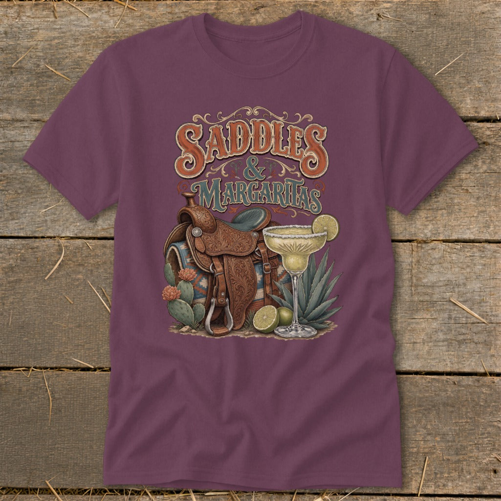 Saddles and Margaritas graphic on a maroon t-shirt with western saddle, cacti, and margarita.