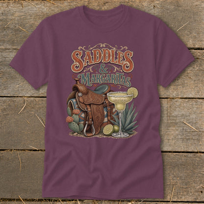 Saddles and Margaritas graphic on a maroon t-shirt with western saddle, cacti, and margarita.