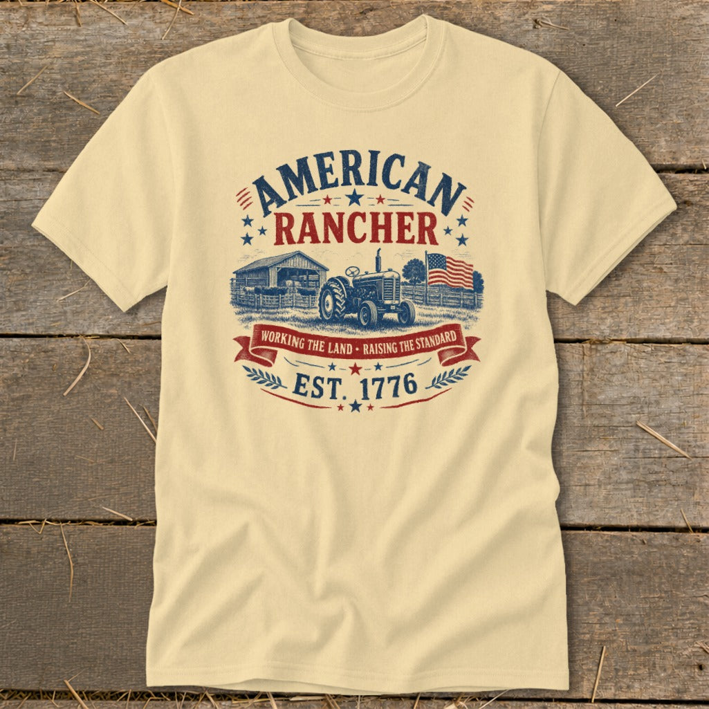 Cream t-shirt with "American Rancher Est. 1776" design featuring a tractor, barn, and flag.
