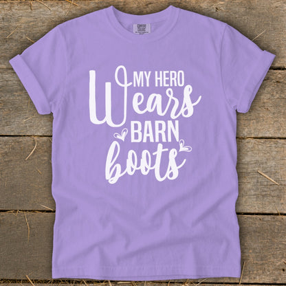 Purple t-shirt with white text reading "My Hero Wears Barn Boots".