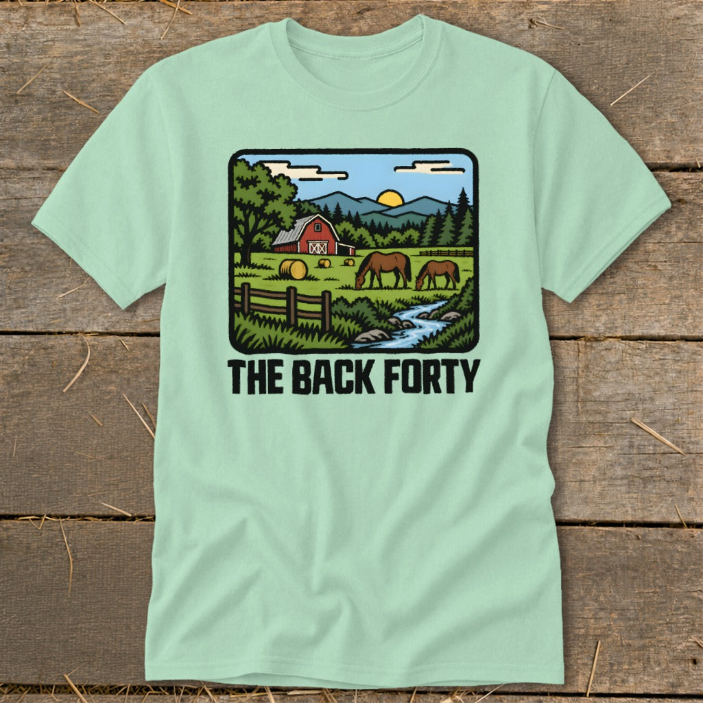 A light green t-shirt with a cartoon farm graphic and the text "THE BACK FORTY".