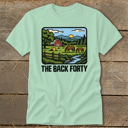 A light green t-shirt with a cartoon farm graphic and the text "THE BACK FORTY".