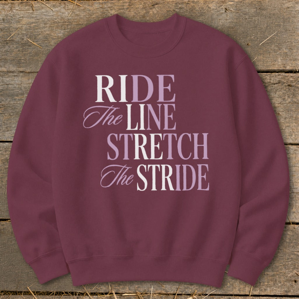 Maroon sweatshirt with "RIDE The LINE STRETCH The STRIDE" text in varying fonts and colors.