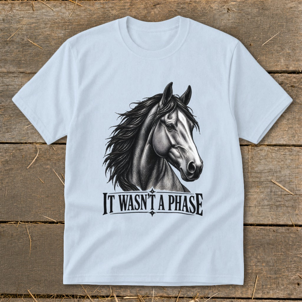 Light blue t-shirt with a black and white sketch of a horse's head and "IT WASN'T A PHASE" text.