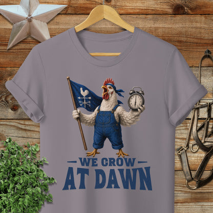 Chicken in overalls holding flag and alarm clock with "We Grow At Dawn" text.