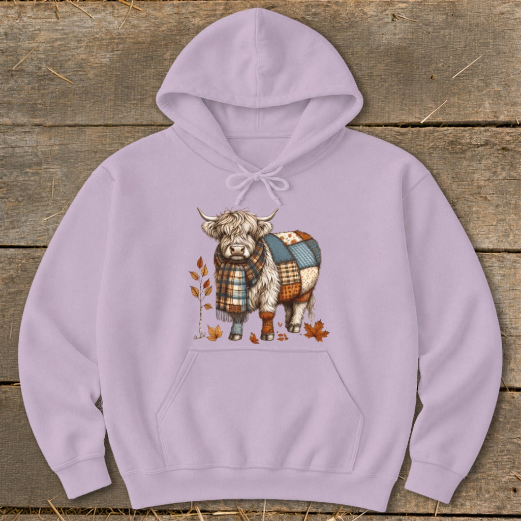 Highland cow with patchwork design and scarf on a lilac hoodie.