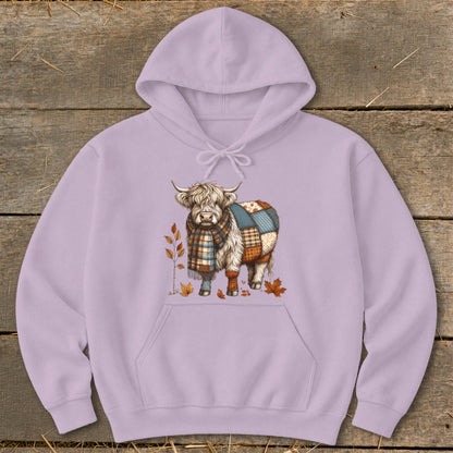 Highland cow with patchwork design and scarf on a lilac hoodie.