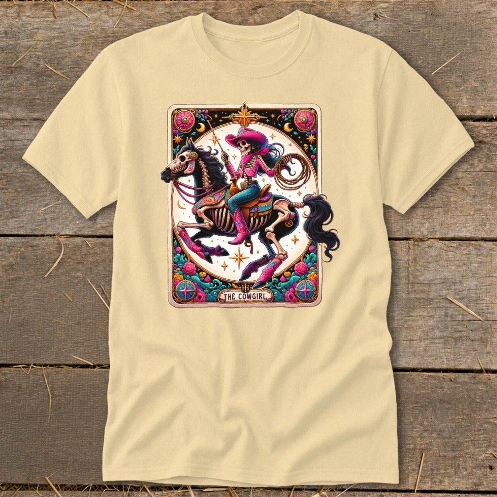 Skeleton cowgirl on a horse with a lasso, "The Cowgirl" text, tarot card design.