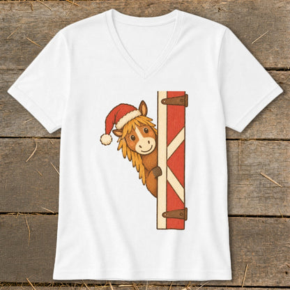 White t-shirt with a cartoon horse wearing a Santa hat peeking around a barn door.