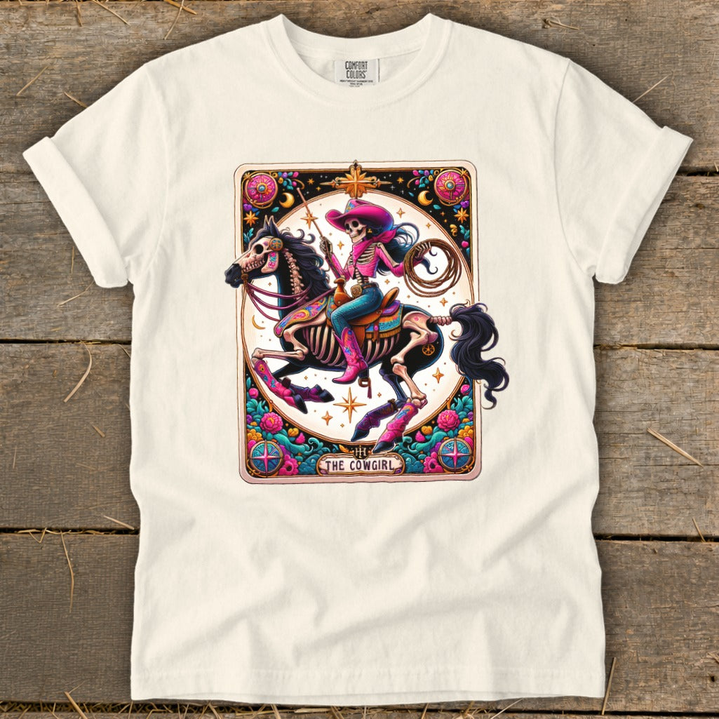 Skeleton cowgirl on horseback wearing a pink hat and boots, with lasso and text "The Cowgirl".